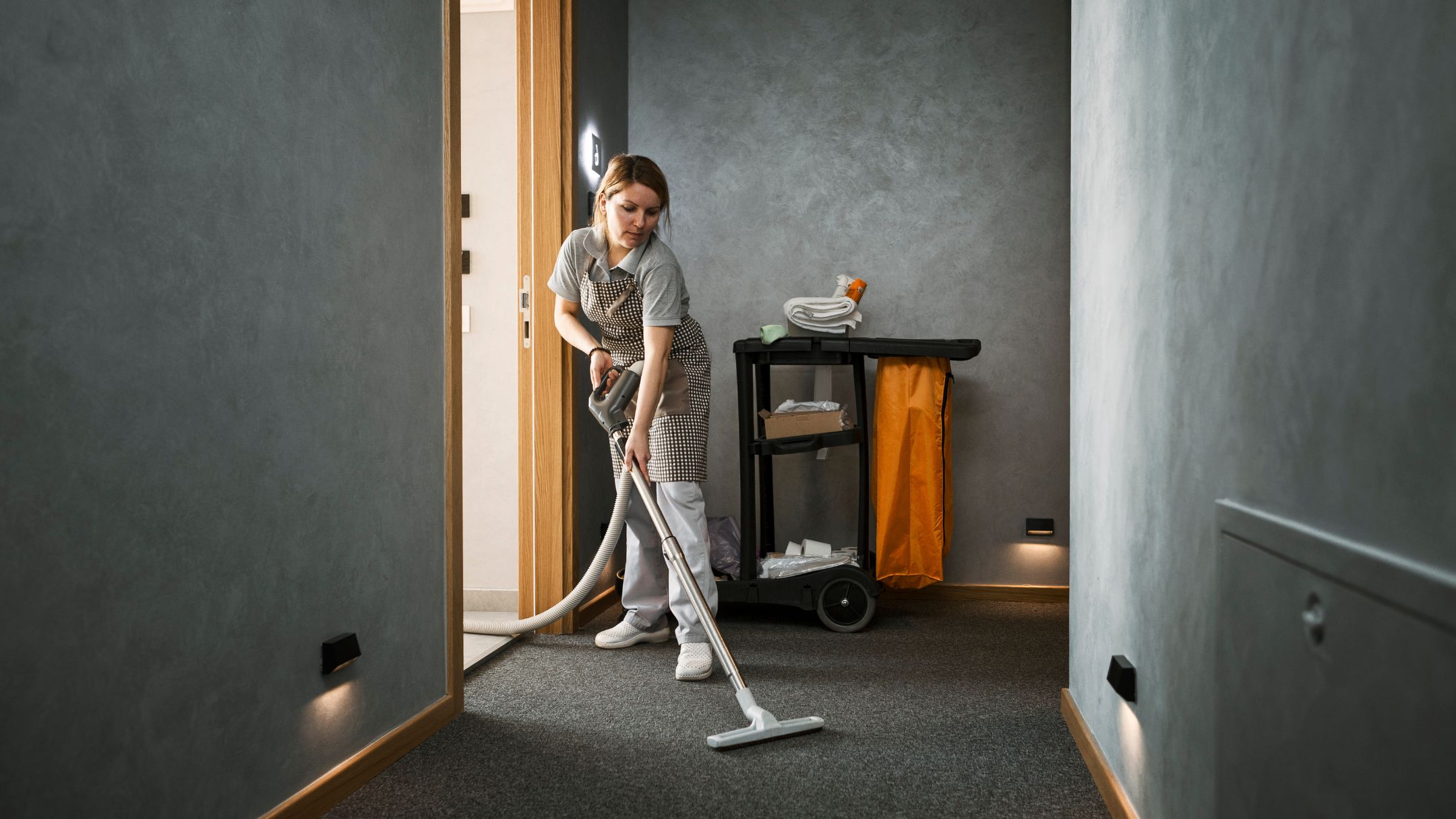 professional cleaning floor with janitorial cart and vaccum