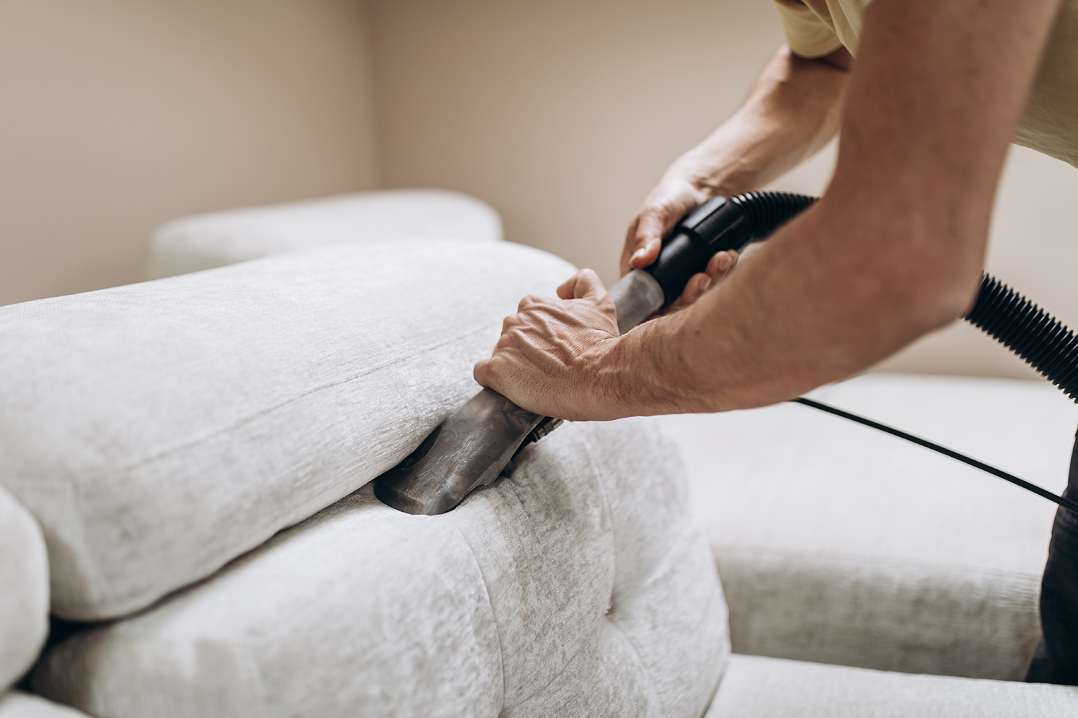 professional doing deep clean on furniture